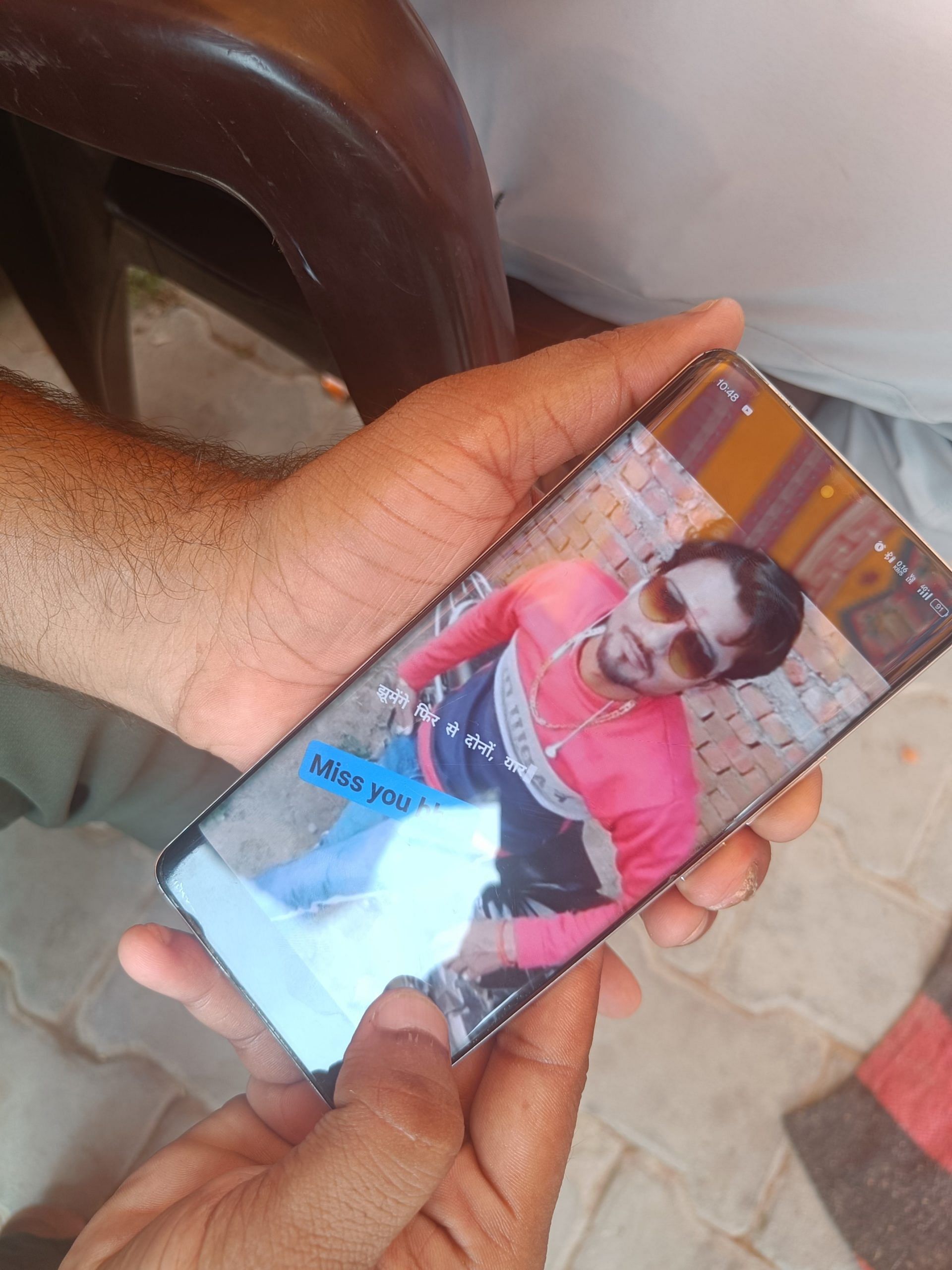 A neighbor of Akash shows his old photo | Photo: Krishan Murari/ThePrint