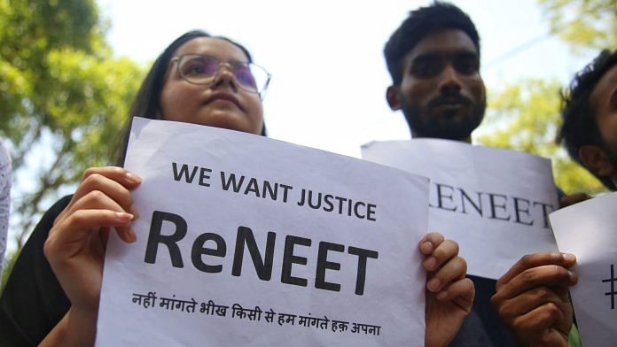 NEET applicants and doctors hold posters and answer sheets while demonstrating a protest at Delhi's Jantar Mantar demanding ReNEET exam | Photo: Manisha Mondal/ThePrint