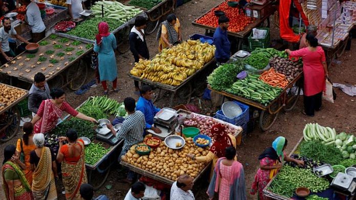 Customers buy fruits and vegetables at an open air evening market in Ahmedabad | REUTERS/Amit Dave/File Photo