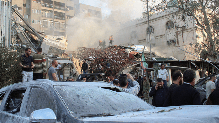 People gather near the damaged site after what Syrian and Iranian media described as an Israeli air strike on Iran's consulate in the Syrian capital Damascus 1 April, 2024 | REUTERS/Firas Makdesi/File Photo