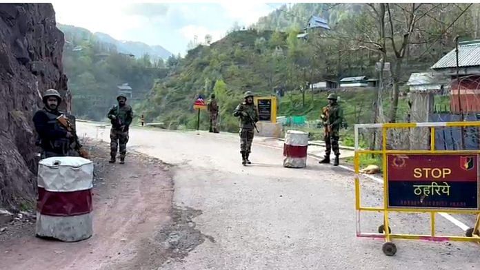 Indian Army and J&K Police personnel stand guard on a road | File photo: ANI