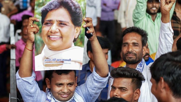 File photo of BSP supporter holding portrait of party chief Mayawati at a public meeting in Lucknow | ANI
