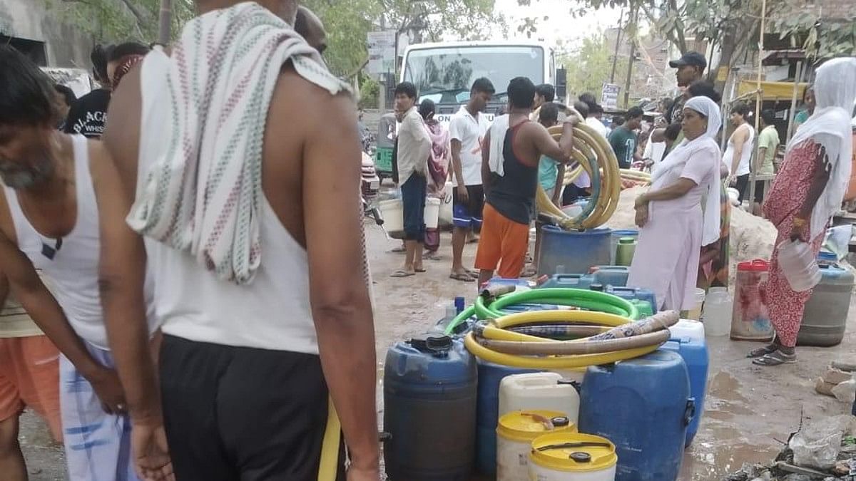 People waiting for water tanker at Sanjay Colony in Okhla Phase-2 | Manavi Sharma for ThePrint