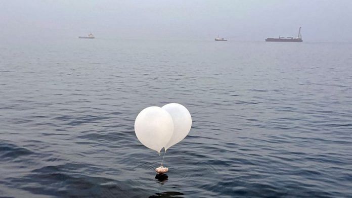 A balloon carrying various objects including what appeared to be trash, believed to have been sent by North Korea, is pictured at the sea off Incheon, South Korea, June 9, 2024. Yonhap via REUTERS