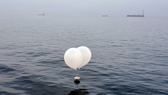 A balloon carrying various objects including what appeared to be trash, believed to have been sent by North Korea, is pictured at the sea off Incheon, South Korea, June 9, 2024. Yonhap via REUTERS