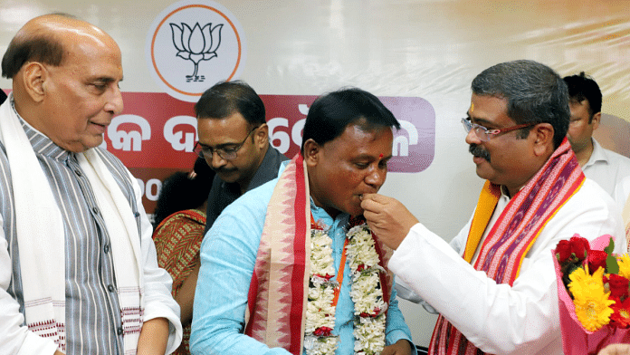 Mohan Charan Majhi is feted by Union Minister Dharmendra Pradhan in Bhubaneswar Tuesday. Defence minister Rajnath Singh is also seen in the picture | ANI