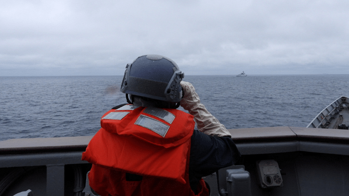 A Taiwanese sailor aboard a Taiwan Navy vessel looks towards a Chinese warship while navigating on waters off Taiwan's western coast | Representative Image | Taiwan Defence Ministry/Handout via Reuters