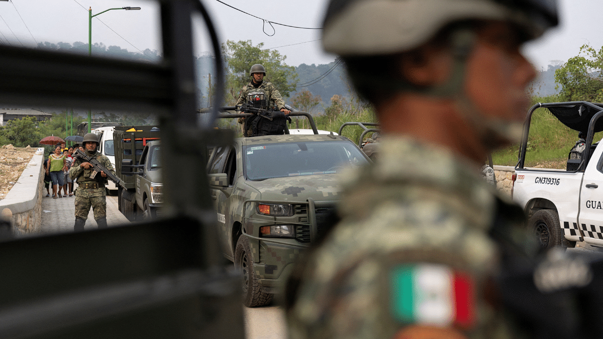 Soldiers patrol as people flee armed gang violence, which has forced residents to evacuate with the help of government authorities that set up camps for displaced individuals, in Yajalon, Chiapas state, Mexico in June | Reuters