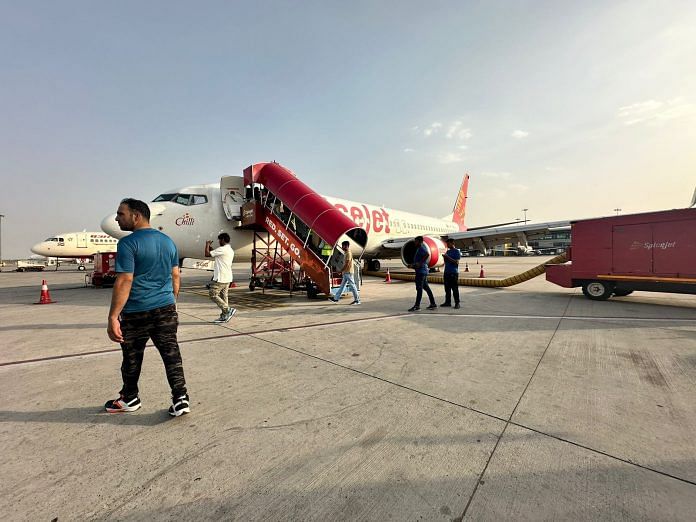 A passenger strolls on the tarmac near the delayed Spicejet flight | By special arrangement | ThePrint