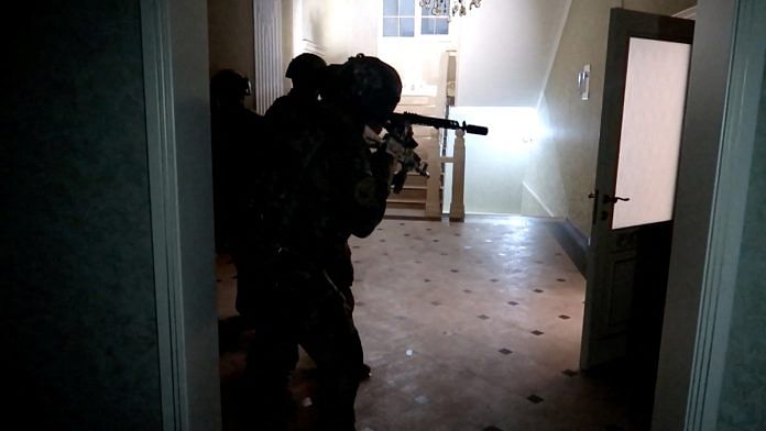 Members of security forces carry out a law enforcement operation after multiple attacks in Makhachkala and Derbent, in an undisclosed location in the region of Dagestan, Russia, in this still image from video released June 24, 2024 | Handout via Reuters