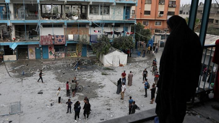 Palestinians inspect the site of an Israeli strike on a UNRWA school sheltering displaced people, amid the Israel-Hamas conflict, in Nuseirat refugee camp in the central Gaza Strip, June 6, 2024 | Reuters File Photo