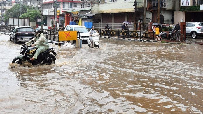 Commuters on a waterlogged road after heavy rainfall following cyclone Remal in Guwahati | Photo: ANI