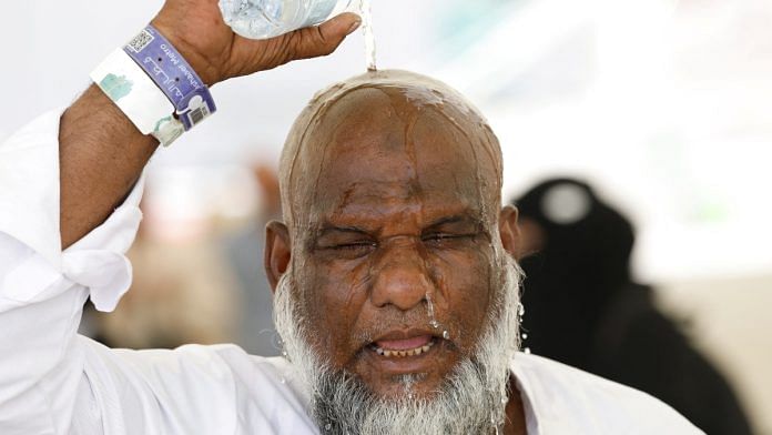 A Muslim pilgrim pours water on his head to cool down from the heat, as he takes part in the annual haj pilgrimage in Mina, Saudi Arabia, June 17, 2024 | Reuters
