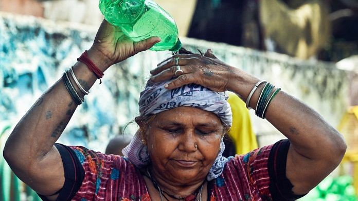 A woman pours water on her head to cool herself amid the ongoing heatwave, at the Swami Vivekananda Camp Chanakyapuri in New Delhi | ANI file photo