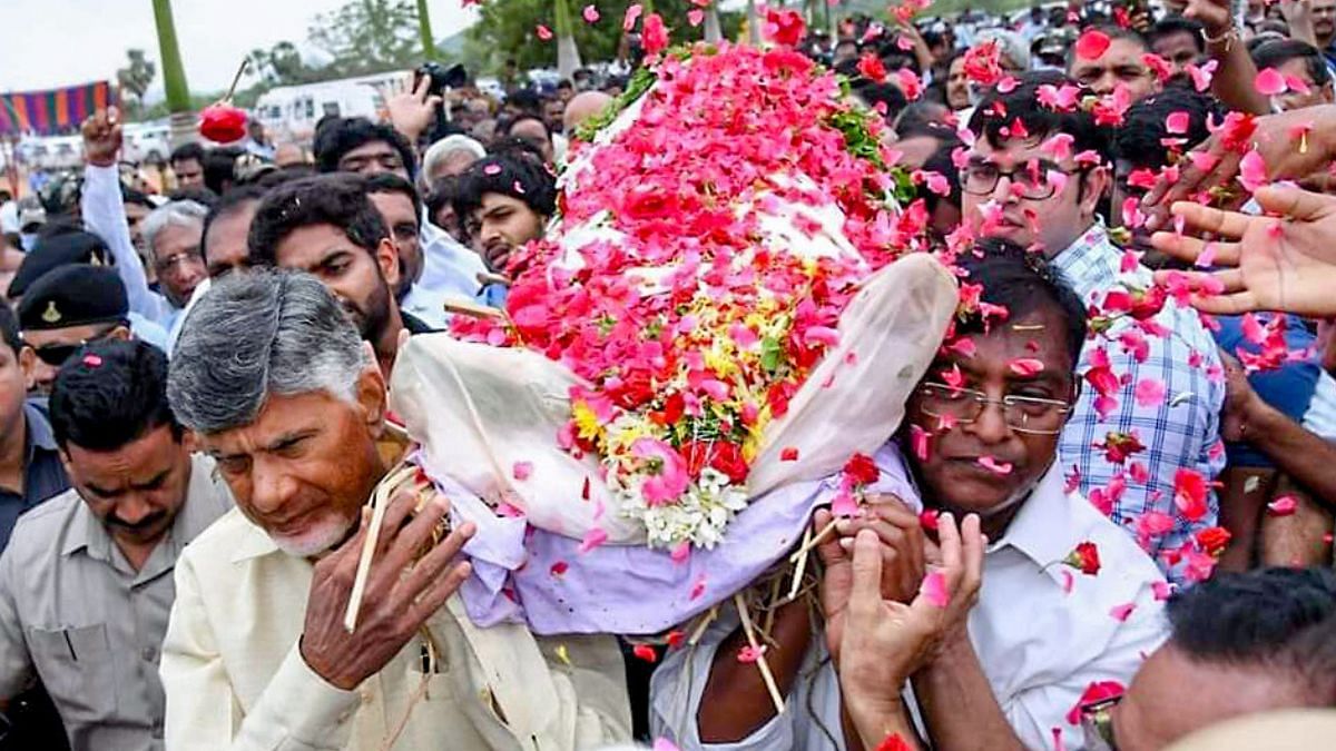 TDP chief N Chandrababu Naidu, along with others, carries the mortal remains of Ramoji Rao during the funeral procession in Hyderabad Sunday | Photo: ANI