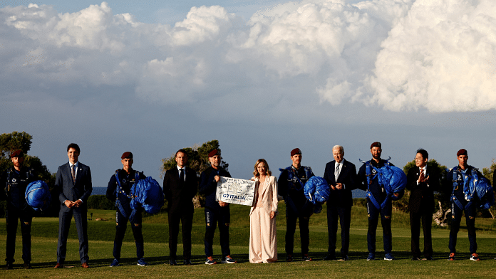 Italy's Prime Minister Giorgia Meloni holds a G7 Italia banner next to U.S. President Joe Biden, Canada's PM Justin Trudeau, France's President Emmanuel Macron, and Japan's PM Fumio Kishida on the first day of the G7 summit, in Savelletri, Italy | File Photo | Reuters /Yara Nardi