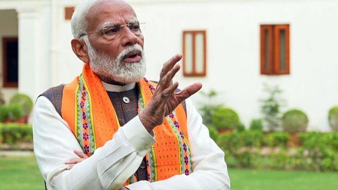 A photo of Prime Minister Narendra Modi speaking at an interview.