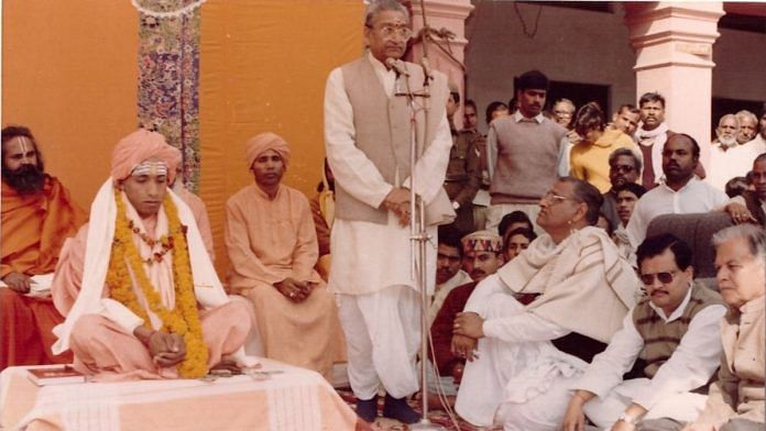 Yogi Adityanath seen at his sanyas ceremony in 1994, with former VHP president Ashok Singhal speaking into a mic in the background | By special arrangement