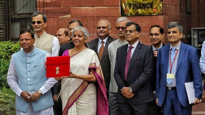 Finance Minister Nirmala Sitharaman holds up a folder with the Government of India's logo as she leaves her office to present the union budget in the parliament in New Delhi | Photo: Praveen Jain/ThePrint