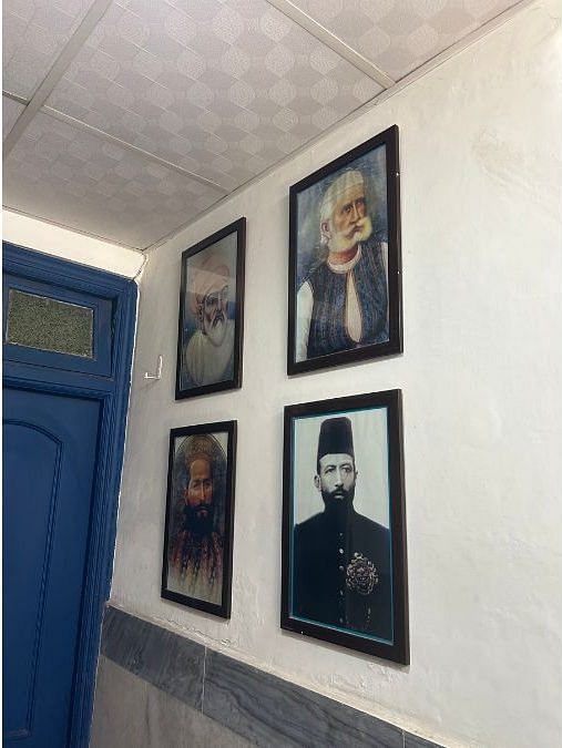 A wall with photos of Muneeb Khan's ancestors in Manzil Haveli Sharif
