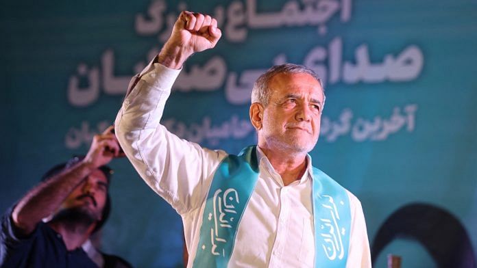 Iranian presidential candidate Masoud Pezeshkian waves during a campaign event in Tehran, Iran, July 3, 2024 | WANA via Reuters