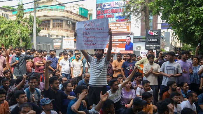 Protesters demand justice for 3 UPSC aspirants who lost their lives after drowning in the basement of Rau's IAS coaching centre in Delhi | Photo: Suraj Singh Bisht, ThePrint