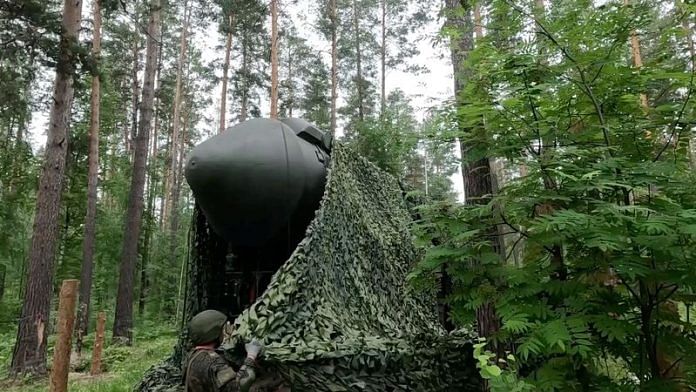 A Russian service member covers a Yars intercontinental ballistic missile system with camouflage netting during drills in an undisclosed location in Russia, in this still image taken from handout footage released July 5, 2024. Russian Defence Ministry/Handout via REUTERS/ File Photo