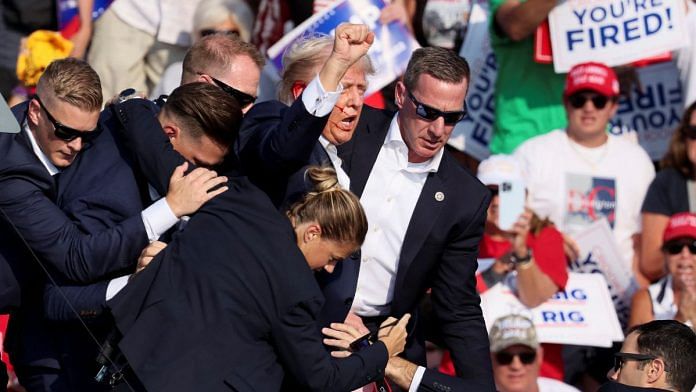 Republican presidential candidate and former US President Donald Trump is assisted by US Secret Service personnel after gunfire rang out during a campaign rally at the Butler Farm Show in Butler, Pennsylvania, US, July 13, 2024 | Photo: REUTERS/Brendan McDermid