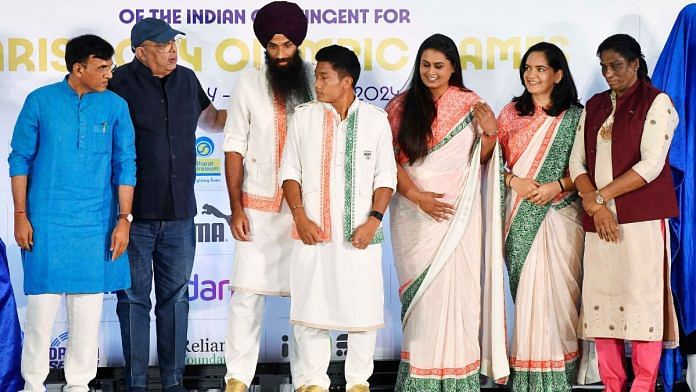 Union Sports and Youth Affairs Minister Mansukh Mandaviya (far left), Indian Olympic Association (IOA) President PT Usha (far right) and fashion designer Tarun Tahiliani (in cap) during the unveiling of the ceremonial dress | ANI