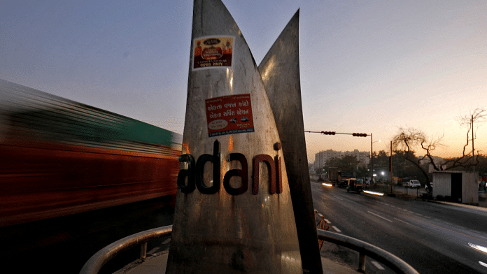 Traffic moves past the logo of the Adani Group installed at a roundabout on the ring road in Ahmedabad | Reuters/Amit Dave/File Photo