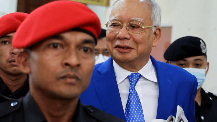 Former Malaysian Prime Minister Najib Razak is escorted by prison officers as the jailed politician leaves the court | Reuters/Hasnoor Hussain/File Photo