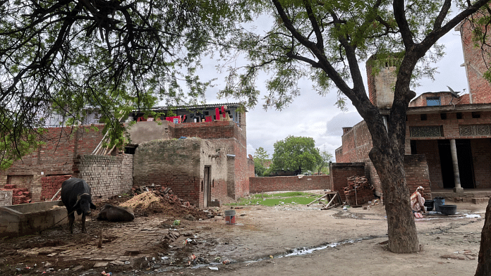 Behind these homes in Saura village lies the pond from which the boy’s slippers and skull cap were found | Antara Baruah | ThePrint