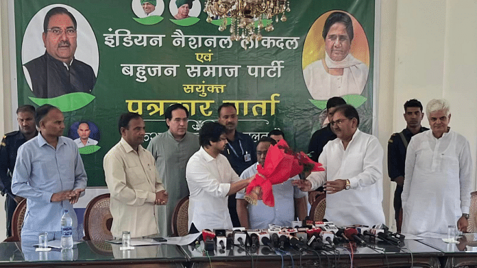 BSP's Akash Anand (left) and INLD's Abhay Singh Chautala (right) exchange pleasantries before the start of a press conference in Chandigarh | Facebook/Indian National Lok Dal - INLD