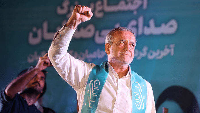 Iranian presidential candidate Masoud Pezeshkian waves during a campaign event in Tehran | Majid Asgaripour/WANA (West Asia News Agency) via REUTERS/ File Photo