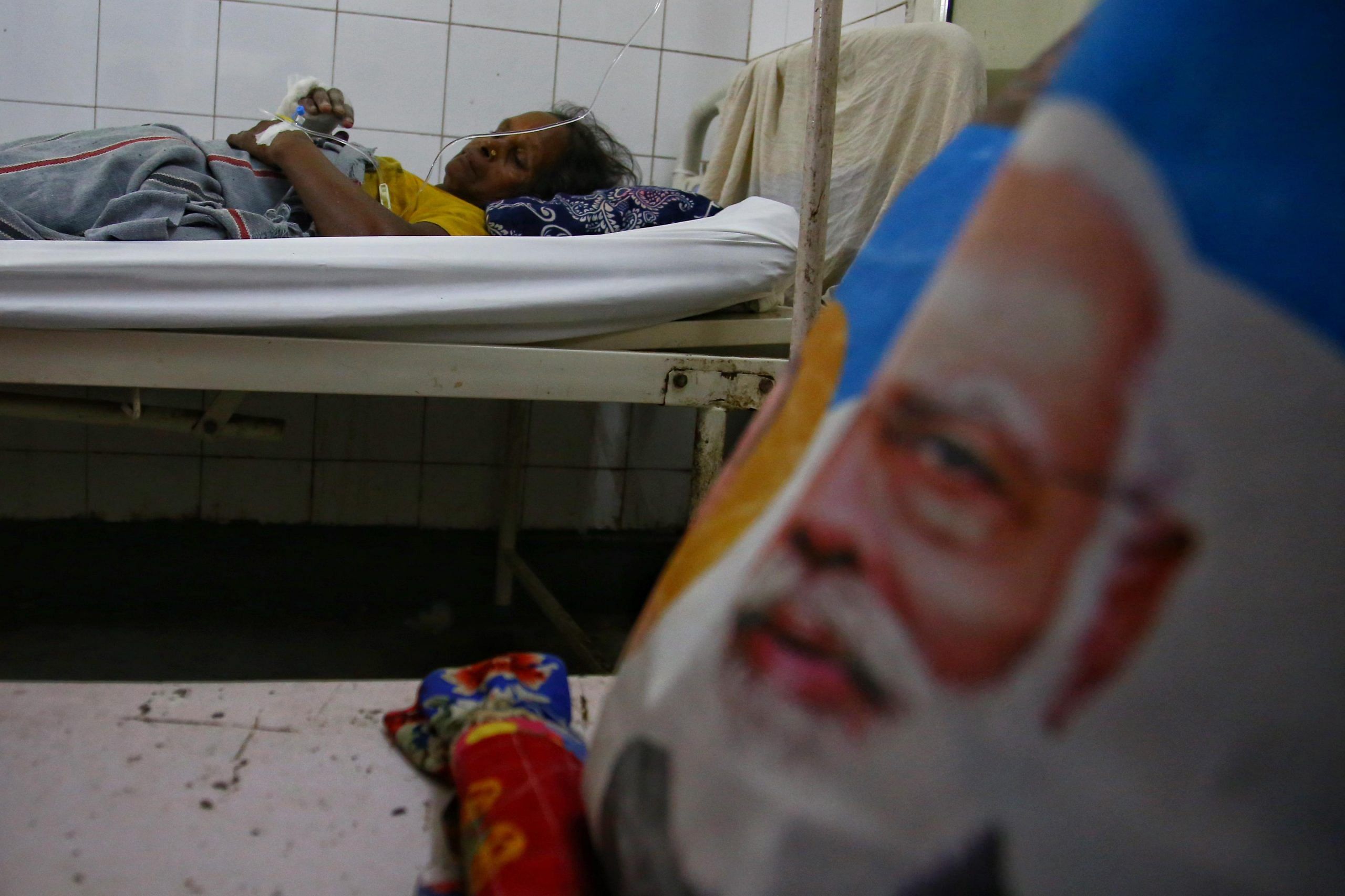 Picture of PM Modi next to a injured victim from the stampede | Manisha Mondel | ThePrint