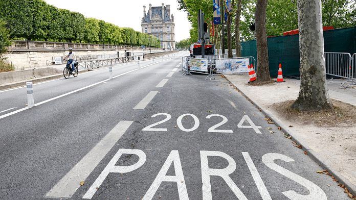 A person is cycling on an empty street ahead of the opening ceremony, July 25, 2024 | Reuters | Peter Cziborra