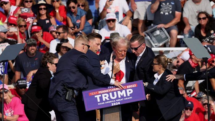 Republican presidential candidate and former U.S. President Donald Trump is assisted by U.S. Secret Service personnel after gunfire rang out during a campaign rally at the Butler Farm Show in Butler, Pennsylvania, U.S., July 13, 2024 | Reuters