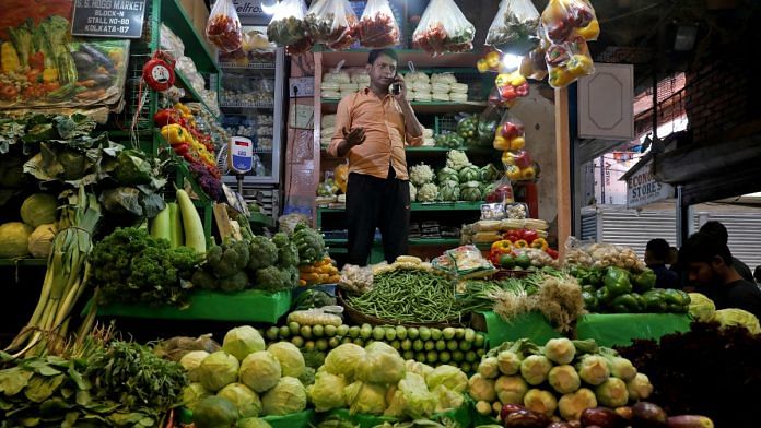 Debashis Dhara, a vegetable vendor, speaks on his mobile phone at a retail market area in Kolkata, India, March 22, 2022. Picture taken March 22, 2022 | Reuters file photo
