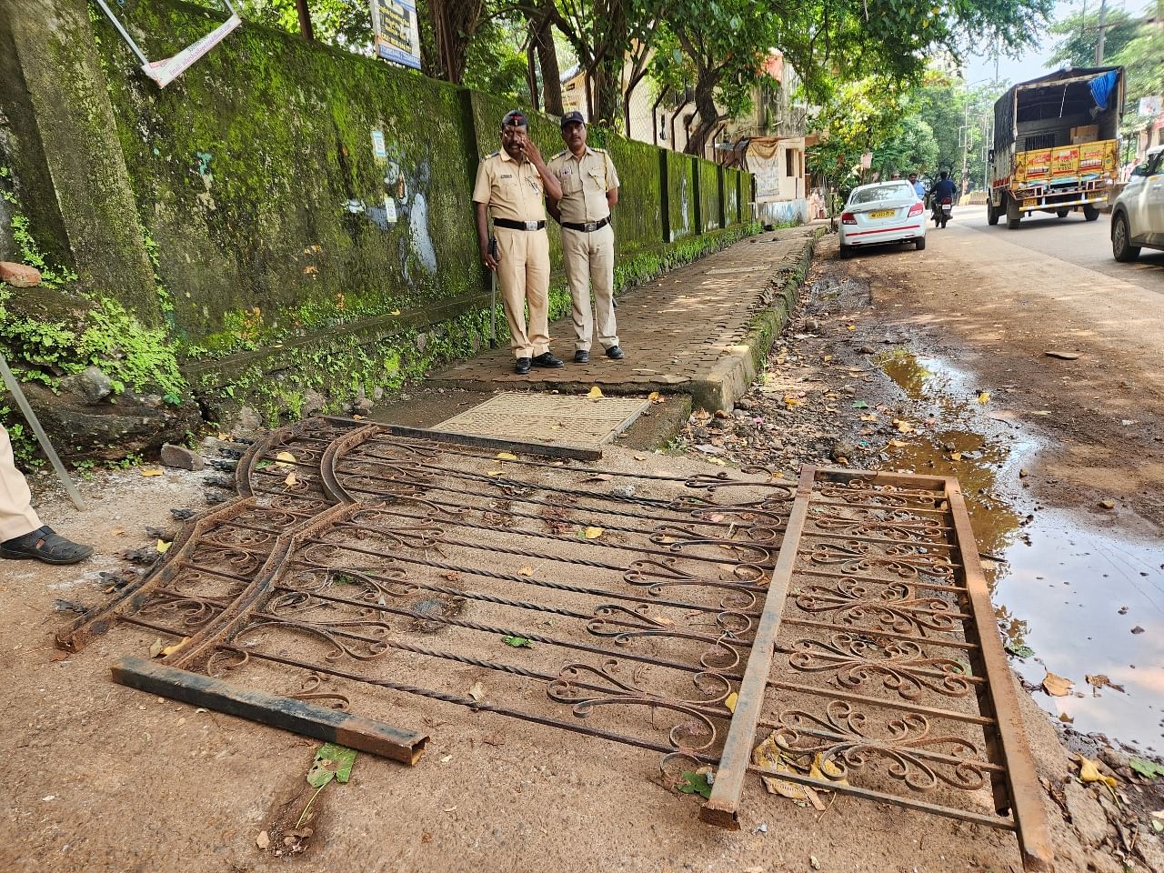 A school gate that was broken by angry protesters a day earlier lies on the ground Wednesday. | Purva Chitnis