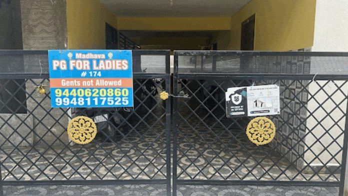 Entrance gate of Madhava PG in Koramangala. Despite signs indicating security facilities, no one was guarding the gate