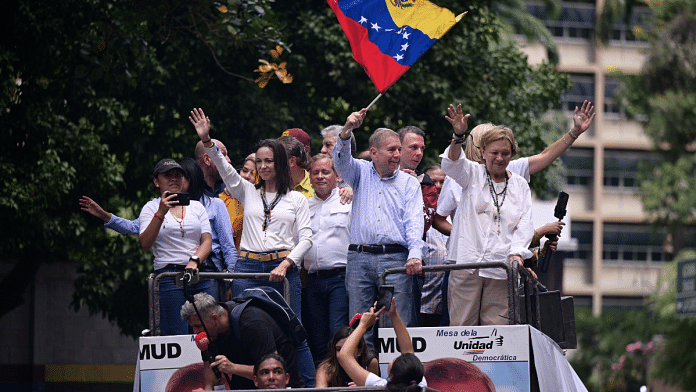 Opposition leader Maria Corina Machado and opposition candidate Edmundo Gonzalez wave as they address supporters after election results awarded Venezuela's President Nicolas Maduro with a third term, in Caracas, Venezuela 30 July, 2024 | Reuters/Gaby Oraa/File Photo