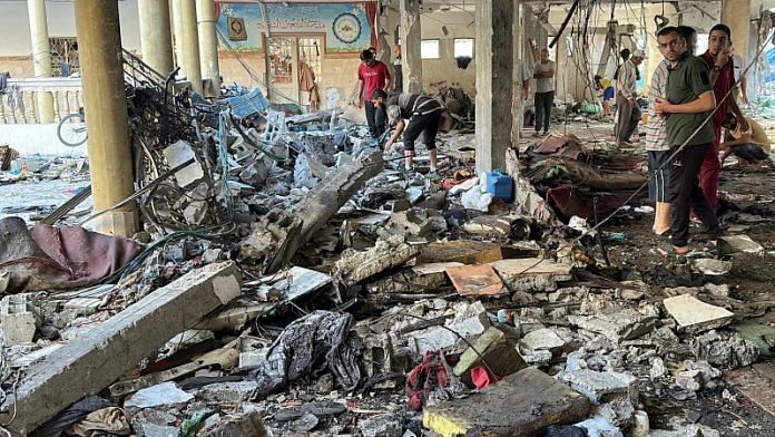 Palestinians inspect the site of an Israeli strike on a school sheltering displaced people, amid the Israel-Hamas conflict, in Gaza City, August 10, 2024. REUTERS/Abed Sabah