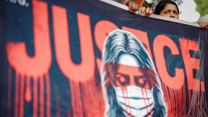 A doctor holds a banner during a protest demanding justice following the rape and murder of a trainee medic at a hospital in Kolkata, in New Delhi on Monday | REUTERS/Adnan Abidi/File Photo