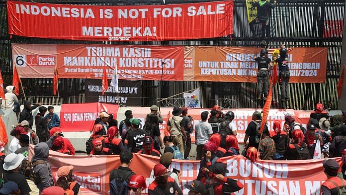 People attend a protest outside the Indonesian Parliament against the revisions to the country's election law in Jakarta, Indonesia on Thursday | REUTERS/Ajeng Dinar Ulfiana