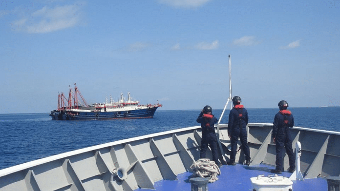 Representational image of Philippine Coast Guard personnel surveying ships believed to be Chinese militia vessels in Sabina Shoal in South China Sea on 27 April 2021, handout by Philippine Coast Guard via Reuters | Credit: Commons