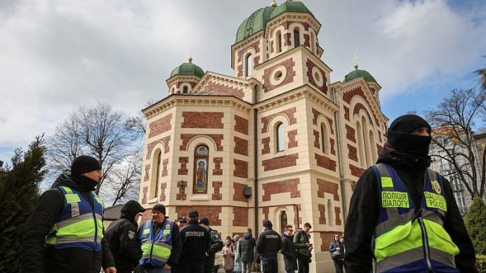 Ukrainian police officers stand next to St. George's Cathedral of the Ukrainian Orthodox Church, in Lviv, Ukraine | REUTERS/Roman Baluk/File Photo