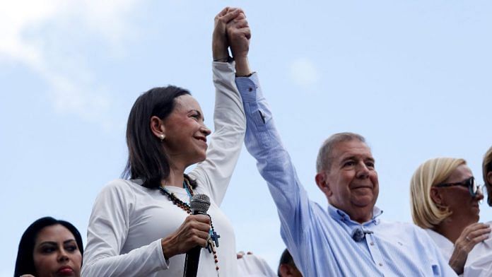 Opposition leader Maria Corina Machado and opposition candidate Edmundo Gonzalez gesture as they address supporters after election results awarded Venezuela's President Nicolas Maduro with a third term, in Caracas, Venezuela July 30, 2024. REUTERS/Leonardo Fernandez Viloria/File Photo