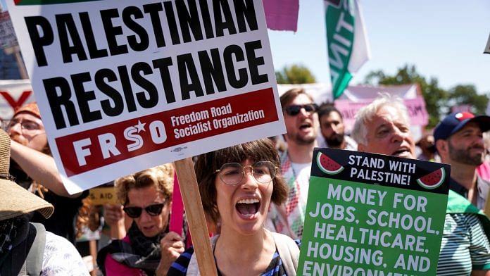 A woman holds a placard, as people take part in the rally 