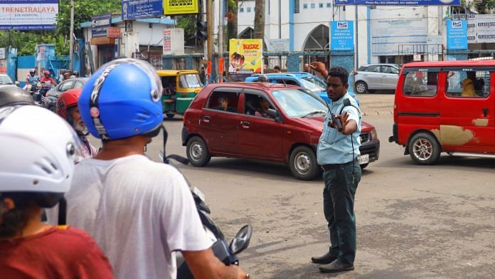 A civic volunteer guides traffic in Kolkata. | Manisha Mondal | ThePrint