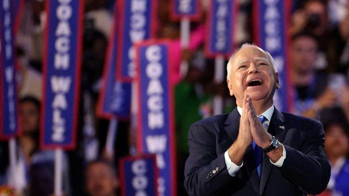 U.S. Democratic vice presidential nominee Minnesota Governor Tim Walz acknowledges applause surrounded by 